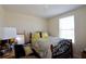 Simple bedroom features a bed, side table and window allowing natural light at 1615 Reflection Cv, St Cloud, FL 34771