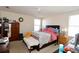 A quaint bedroom features natural light, a comfortable bed, and classic wood furnishings at 1615 Reflection Cv, St Cloud, FL 34771