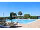 Community pool with lounge chairs, umbrellas, and tables, perfect for relaxation and socializing at 1615 Reflection Cv, St Cloud, FL 34771