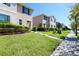 Street view showcasing a row of well-maintained townhomes with manicured lawns at 1615 Reflection Cv, St Cloud, FL 34771