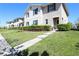Street view showcasing a row of well-maintained townhomes with manicured lawns at 1615 Reflection Cv, St Cloud, FL 34771
