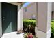 Inviting doorway showcasing green door, neutral walls, and decorative potted plants at 1615 Reflection Cv, St Cloud, FL 34771