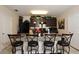 Modern kitchen features granite countertops, dark cabinets, and four barstools at the breakfast bar at 1615 Reflection Cv, St Cloud, FL 34771