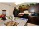 Kitchen featuring granite counters, dark cabinets, modern appliances, backsplash, and tile flooring at 1615 Reflection Cv, St Cloud, FL 34771