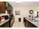 This kitchen includes granite countertops, modern appliances, tile floors, and dark cabinets at 1615 Reflection Cv, St Cloud, FL 34771