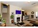 Open-concept living room with fireplace, tile flooring, and a view into the modern kitchen with bar seating at 1615 Reflection Cv, St Cloud, FL 34771
