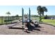 Community playground featuring slides, climbing structures, and comfortable benches with lake views at 1615 Reflection Cv, St Cloud, FL 34771