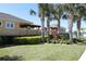 Exterior view of the community pool area entrance with lush landscaping and palm trees at 1615 Reflection Cv, St Cloud, FL 34771