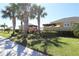Exterior view of the community pool area entrance with lush landscaping and palm trees at 1615 Reflection Cv, St Cloud, FL 34771