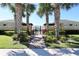 Exterior of gated community pool entrance, framed by palm trees and lush landscaping at 1615 Reflection Cv, St Cloud, FL 34771
