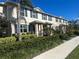 Charming townhomes with blue shutters and nicely manicured landscaping create curb appeal at 16180 Arbor Crest Aly, Winter Garden, FL 34787