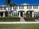 Inviting townhome with blue shutters, a tidy landscaped yard, and a welcoming entryway at 16180 Arbor Crest Aly, Winter Garden, FL 34787