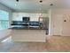 Bright kitchen with white cabinets, granite countertops, stainless steel appliances, and an island at 16180 Arbor Crest Aly, Winter Garden, FL 34787