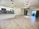 Open-concept kitchen and living room with pendant lighting and ceramic tile flooring at 16180 Arbor Crest Aly, Winter Garden, FL 34787