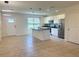 Spacious open-concept kitchen and living area with modern lighting and tile flooring at 16180 Arbor Crest Aly, Winter Garden, FL 34787