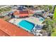 Top-down shot of the pristine pool and spa area, surrounded by palm trees and community buildings at 1631 Little Falls Cir # 92, Orlando, FL 32807