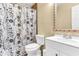 Bathroom featuring a toilet, vanity, and a shower with a floral shower curtain, providing a functional space at 1631 Little Falls Cir # 92, Orlando, FL 32807