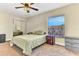 Bright bedroom with neutral carpet, ceiling fan, a bed, and a window offering a view of the outdoors at 1631 Little Falls Cir # 92, Orlando, FL 32807