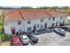 Charming two-story townhomes in a well-maintained community, showcasing assigned parking and red-tiled roofs at 1631 Little Falls Cir # 92, Orlando, FL 32807