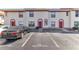 Charming townhome with a red door, cream stucco and red trim plus reserved visitor parking at 1631 Little Falls Cir # 92, Orlando, FL 32807