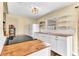 Updated kitchen featuring butcher block counters, white cabinetry, and a smooth top electric range at 1631 Little Falls Cir # 92, Orlando, FL 32807