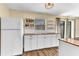 Updated kitchen featuring butcher block counters, white cabinetry, and open shelving for added storage at 1631 Little Falls Cir # 92, Orlando, FL 32807