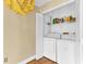 Laundry area including washer, dryer, shelving and a unique yellow light fixture above at 1631 Little Falls Cir # 92, Orlando, FL 32807