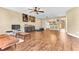 The open-concept living room features wood tile flooring, a ceiling fan, and a view into the kitchen at 1631 Little Falls Cir # 92, Orlando, FL 32807