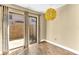 This room features sliding glass doors out to a backyard, wood floors and a unique yellow light fixture at 1631 Little Falls Cir # 92, Orlando, FL 32807