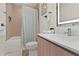 Bright bathroom featuring a shower-tub combo and a modern vanity with an illuminated mirror at 17220 Blessing Dr, Clermont, FL 34714