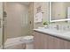 Well-lit bathroom featuring a glass shower, modern vanity, and stylish decor at 17220 Blessing Dr, Clermont, FL 34714
