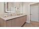 Modern bathroom features a double sink vanity, illuminated mirrors, and contemporary finishes at 17220 Blessing Dr, Clermont, FL 34714