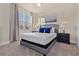 Sun-filled bedroom with a tufted headboard, large window, and neutral decor at 17220 Blessing Dr, Clermont, FL 34714