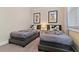 Charming bedroom with two twin beds and Mickey Mouse themed bedding at 17220 Blessing Dr, Clermont, FL 34714