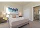 Inviting bedroom with a serene ambiance and a view to the en-suite bathroom at 17220 Blessing Dr, Clermont, FL 34714