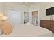 Bright bedroom features closet, stairs, and television over dark wood dresser at 17220 Blessing Dr, Clermont, FL 34714