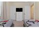 Bedroom featuring two twin beds with Mickey Mouse bedding and tv at 17220 Blessing Dr, Clermont, FL 34714