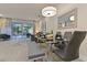Open-concept dining area with glass table, bench seating, and access to screened in outdoor living at 17220 Blessing Dr, Clermont, FL 34714