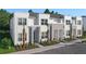 Contemporary townhomes showcasing stone accents and well-maintained grounds at 17220 Blessing Dr, Clermont, FL 34714