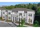 Charming two-story townhomes showcase white facade, and meticulously landscaped grounds, creating a welcoming curb appeal at 17220 Blessing Dr, Clermont, FL 34714