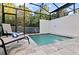 Screened in patio featuring a private in-ground spa with lounge chairs at 17220 Blessing Dr, Clermont, FL 34714