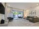 Comfortable living room with a large TV, stylish furniture, and a view of the outdoor patio at 17220 Blessing Dr, Clermont, FL 34714
