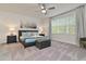 Serene bedroom with natural light, ceiling fan, and decoratively appointed bed at 17220 Blessing Dr, Clermont, FL 34714