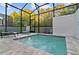 Relaxing screened-in spa featuring comfortable seating and a view of mature trees at 17220 Blessing Dr, Clermont, FL 34714