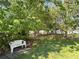 Lush backyard with a white bench, perfect for enjoying the serene and natural surroundings at 224 Montana Ave, St Cloud, FL 34769