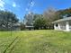 Spacious backyard featuring a white shed, perfect for storage, with lush green grass at 224 Montana Ave, St Cloud, FL 34769