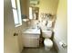 Traditional bathroom features a toilet, sink, and small vanity with decor at 224 Montana Ave, St Cloud, FL 34769