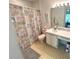 Compact bathroom with a shower/tub, single vanity, toilet, and colorful shower curtain at 224 Montana Ave, St Cloud, FL 34769
