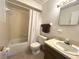 Modest bathroom offers a shower-tub combo, toilet, vanity, and neutral color scheme at 224 Montana Ave, St Cloud, FL 34769