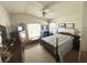 Traditional bedroom with a wooden bed frame, dresser, chair, and two windows at 224 Montana Ave, St Cloud, FL 34769